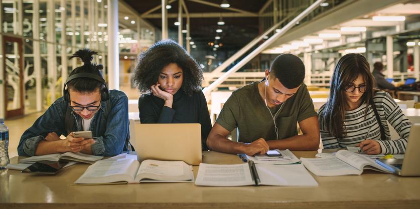 A group of university students studying in a library