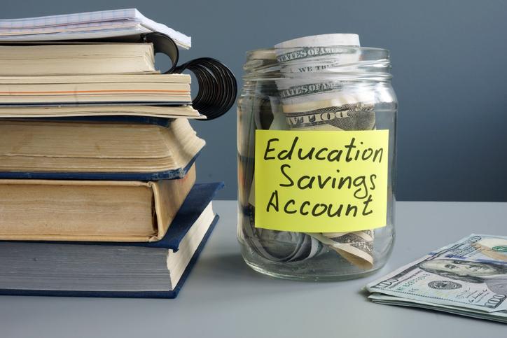 Jar containing coins saving money for education