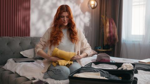 Woman packing suitcase